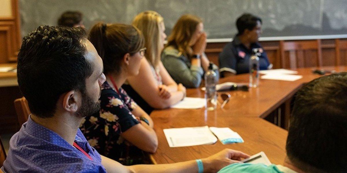 Students sitting in a class listening to a speaker