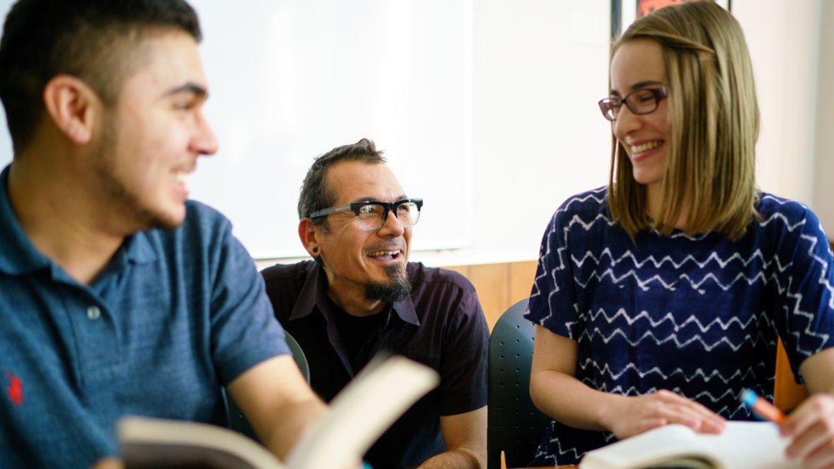 Students in class talking to a professor